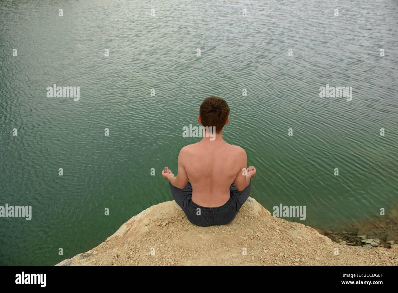 Man sitting on rock shore hi-res stock photography and images - Alamy