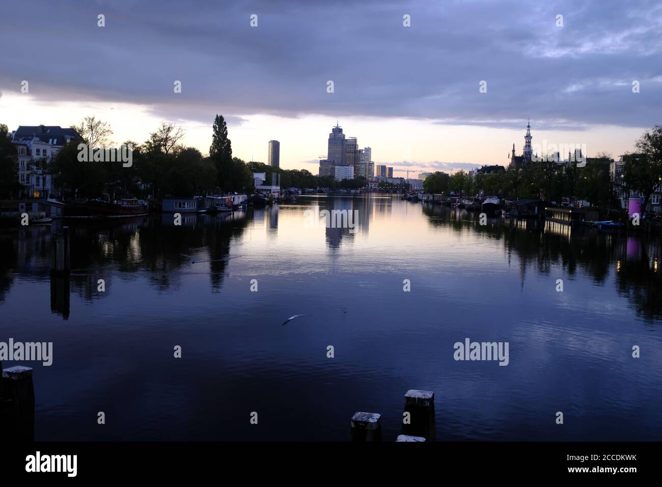 Beautiful morning light in the center of Amsterdam with the skyline of the south of Amsterdam over the Amstel river Stock Photo