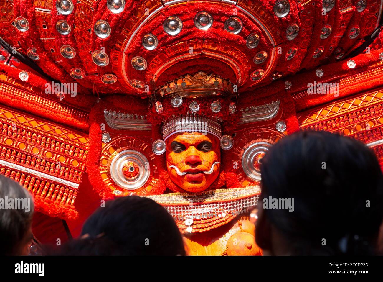 Traditional Theyyam performer adorned in elaborate costume and makeup ...