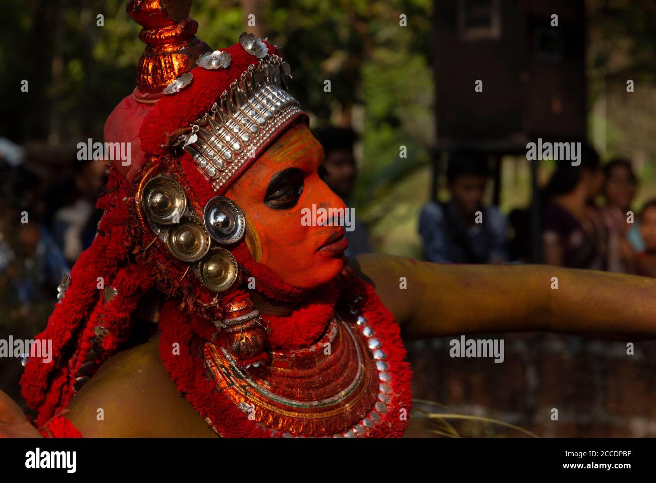 Traditional Theyyam performer adorned in elaborate costume and makeup ...