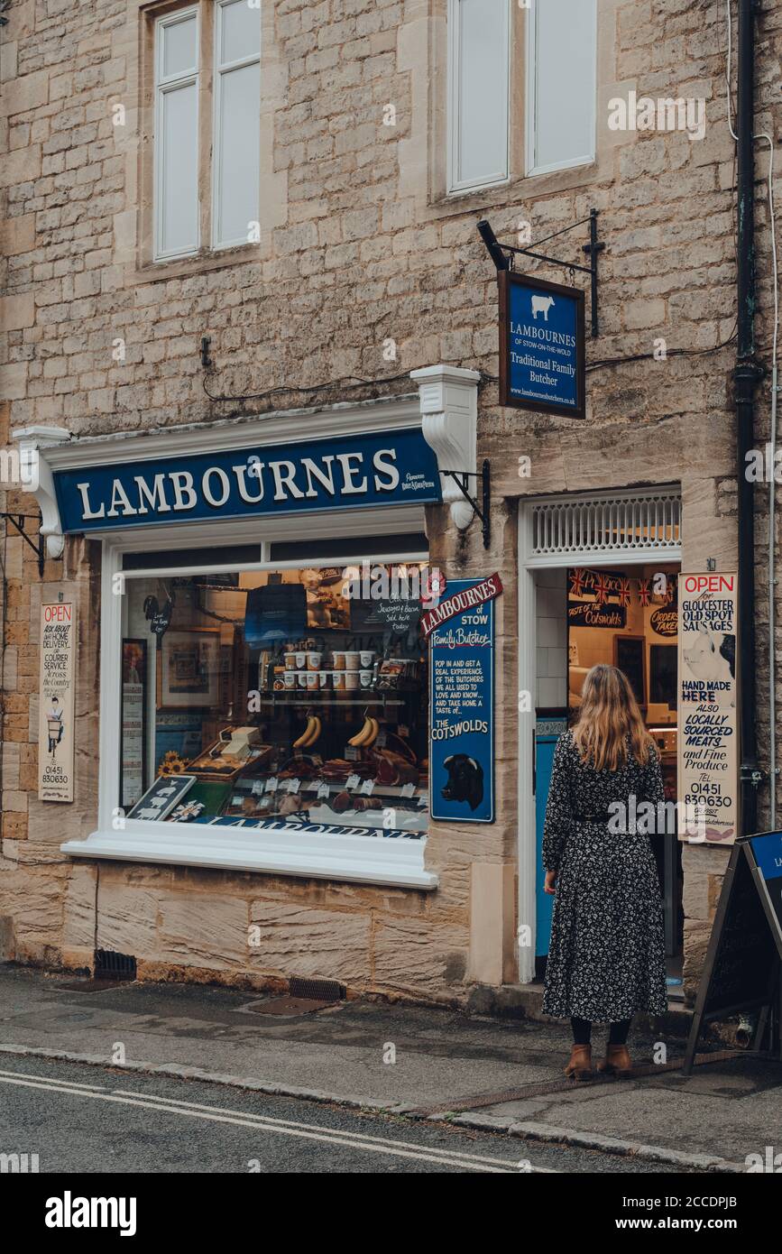 Stow-on-the-Wold, UK - July 10, 2020: Woman standing on a street, waiting to enter Lambournes butcher shop in Stow-on-the-Wold, a market town in Cotsw Stock Photo