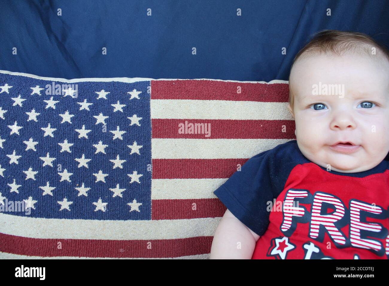 A proud American baby with natural matching colors of the United States of America: Red, White, and Blue. Stock Photo