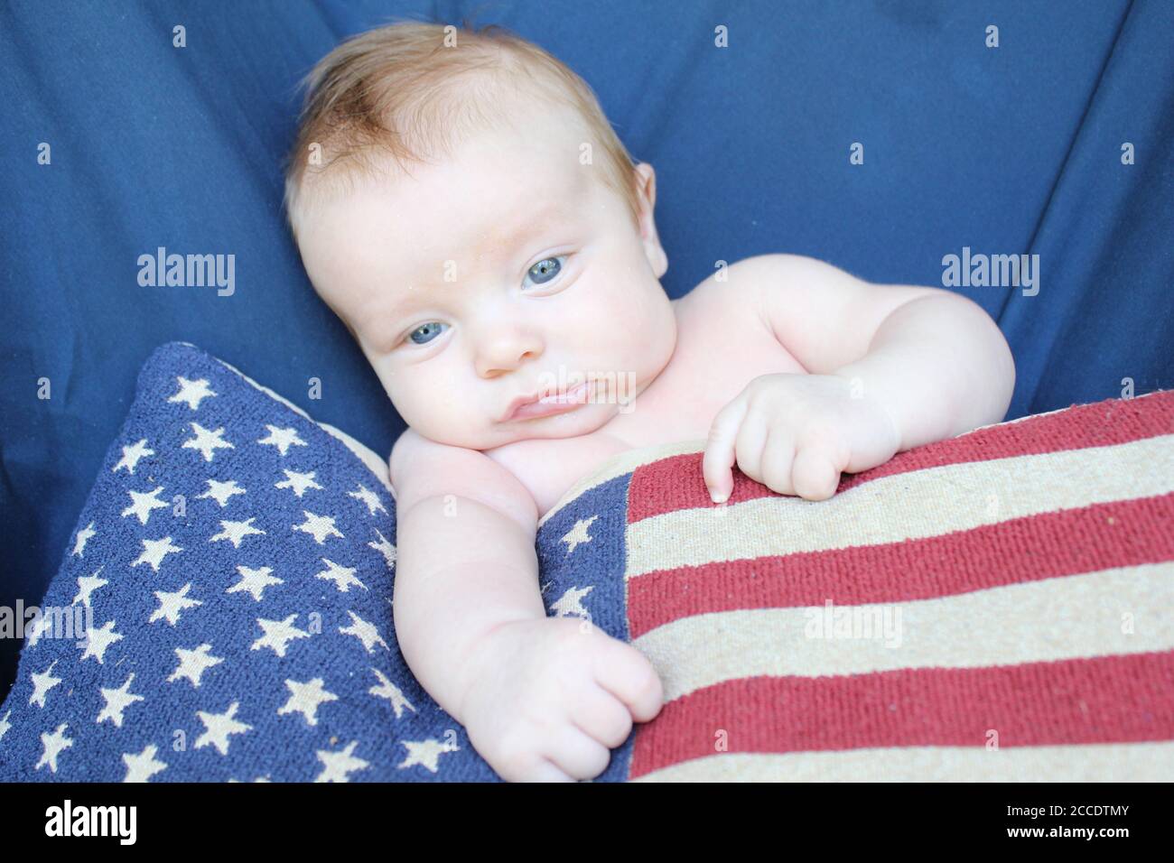 A proud American baby with natural matching colors of the United States of America: Red, White, and Blue. Stock Photo
