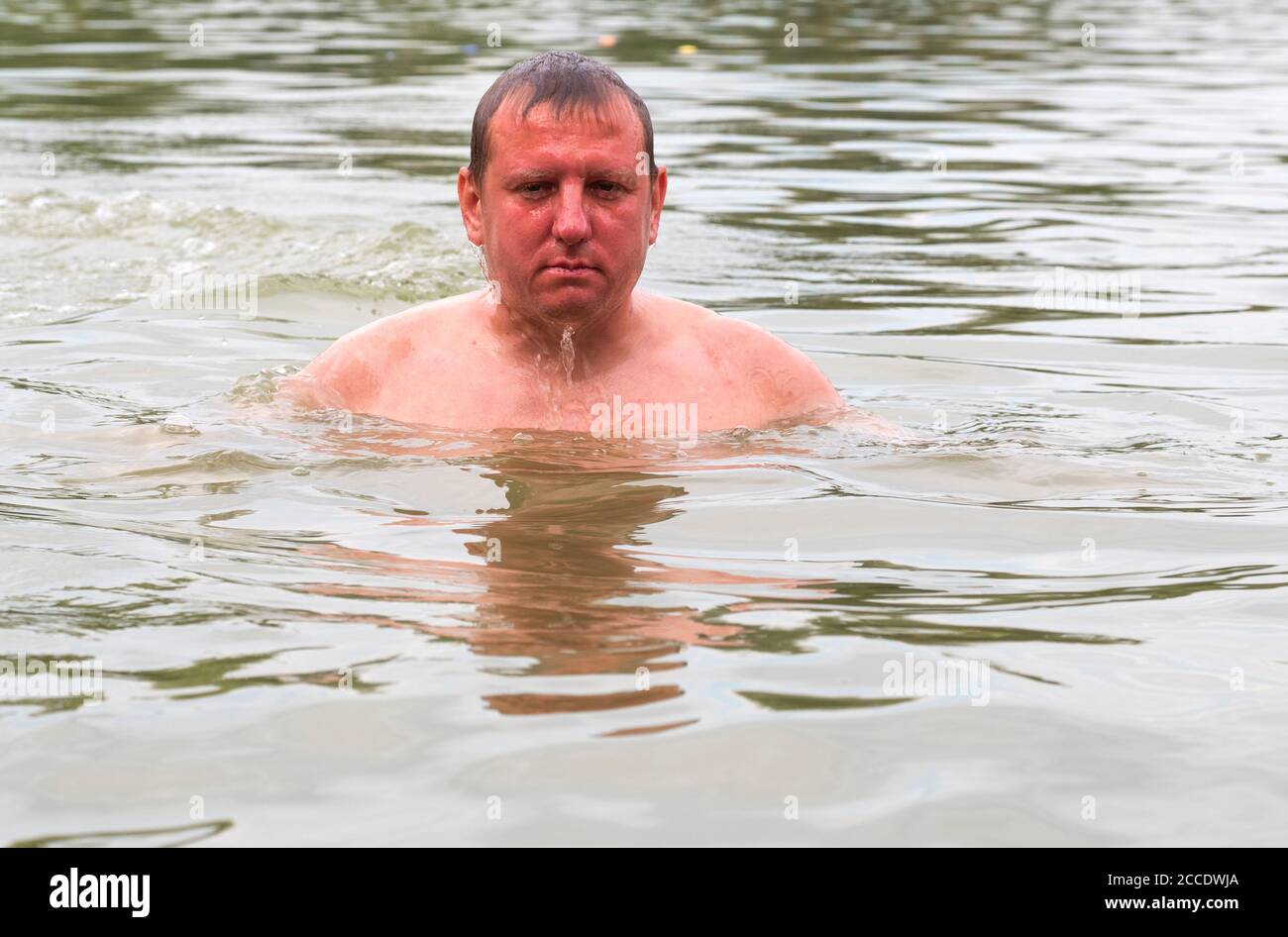 Water flows down the face of a young Caucasian man emerging from the lake  Stock Photo - Alamy