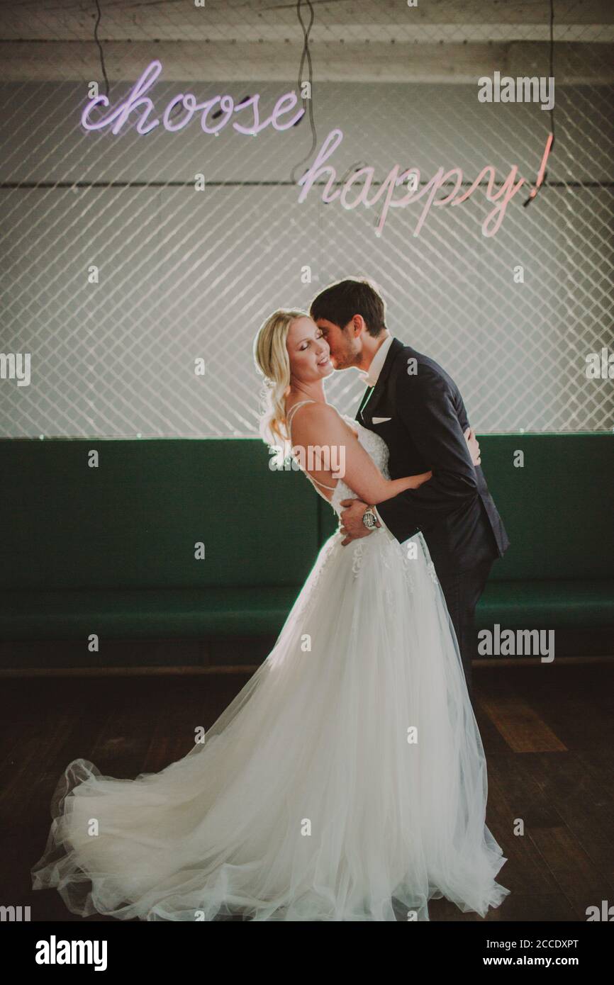 Happy newlyweds kissing indoor hi-res stock photography and images - Alamy