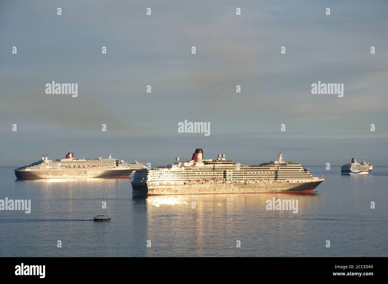 Cruise ships: Queen Victoria, Queen Mary 2, Marella Explorer and Marella Discovery anchored in Weymouth Bay. Mothballed during the Covid-19 pandemic. Stock Photo
