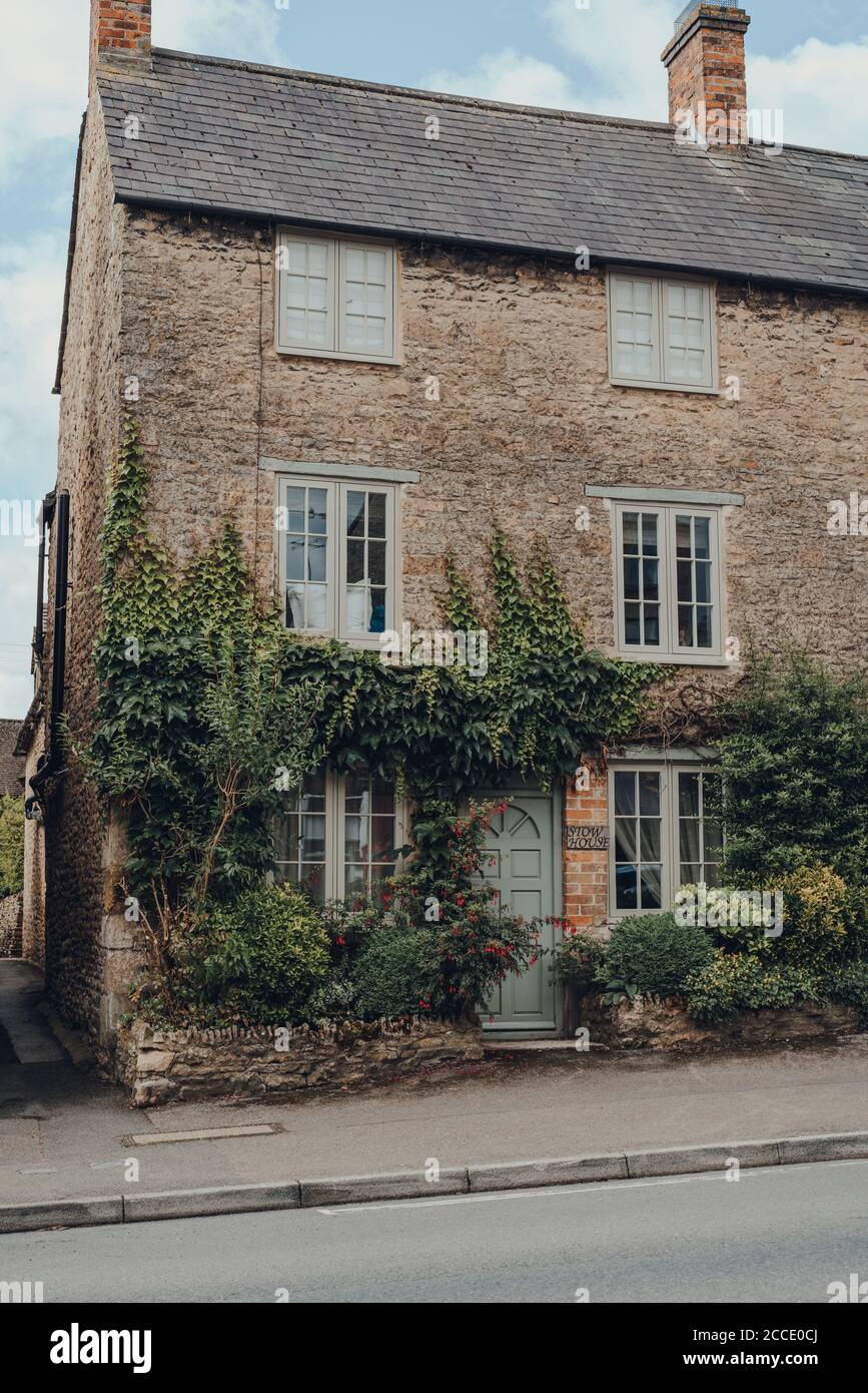 Stow-on-the-Wold, UK - July 10, 2020: Facade of a traditional stone house covered in climber plants in Stow-on-the-Wold, a market town in Cotswolds, U Stock Photo