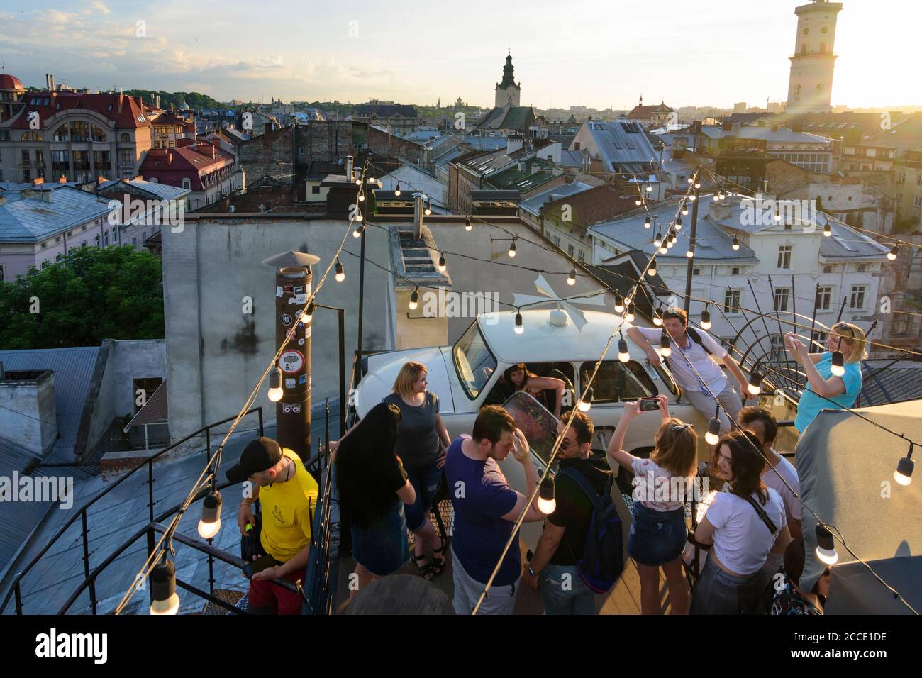Lviv (Lwiw, Lemberg), Dim Lehend (House of Legends), roof terrace, car Trabant 601, bar, roofs of Old Town, tower of Town Hall, people in Lviv Oblast, Stock Photo