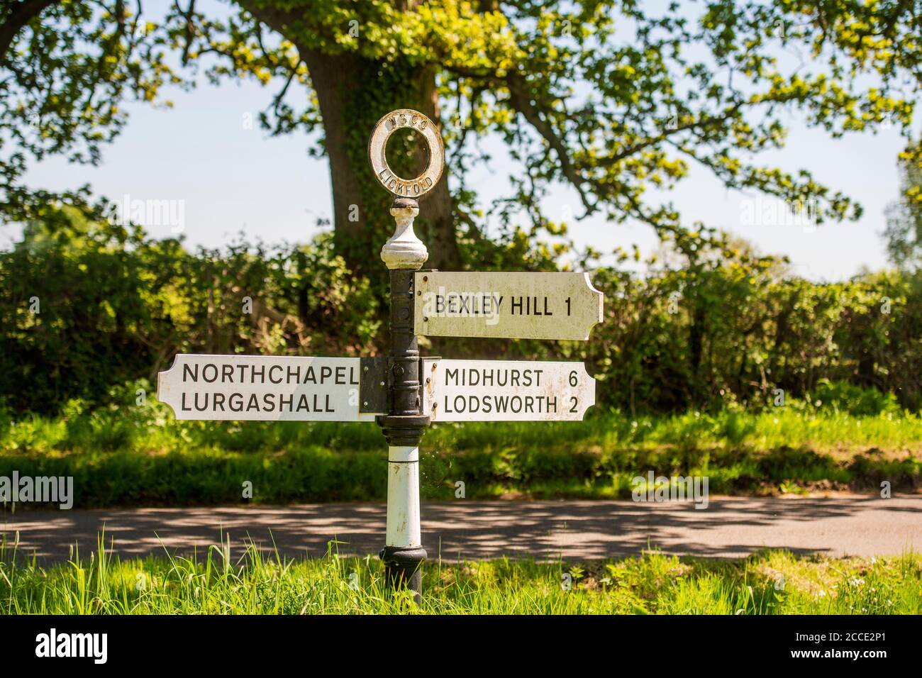 A signpost in the village of Lickfold. Destinations on the fingerpost are to Bexley Hill, Midhurst, Lodsworth, Northchapel, and Lurgashall. Stock Photo