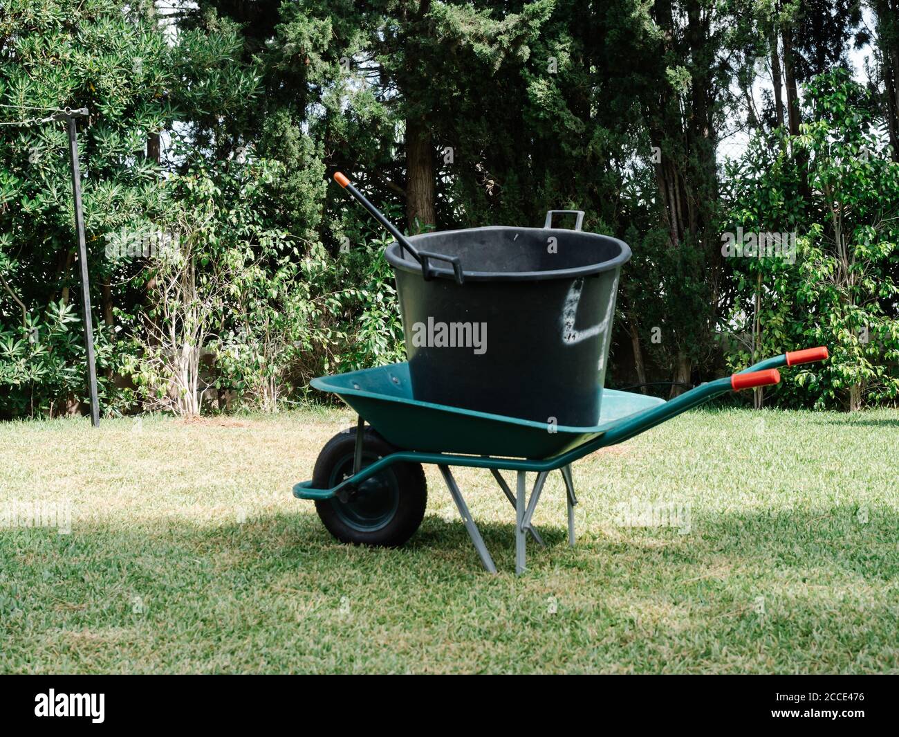 ubber bucket on a wheelbarrow in a big garden Stock Photo Alamy