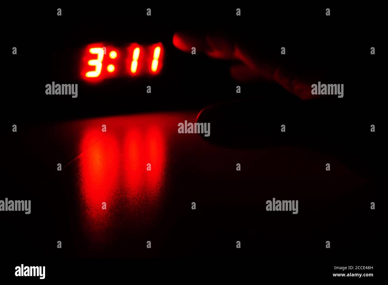 turning off the ringing alarm clock in the night - night shift- early shift Stock Photo