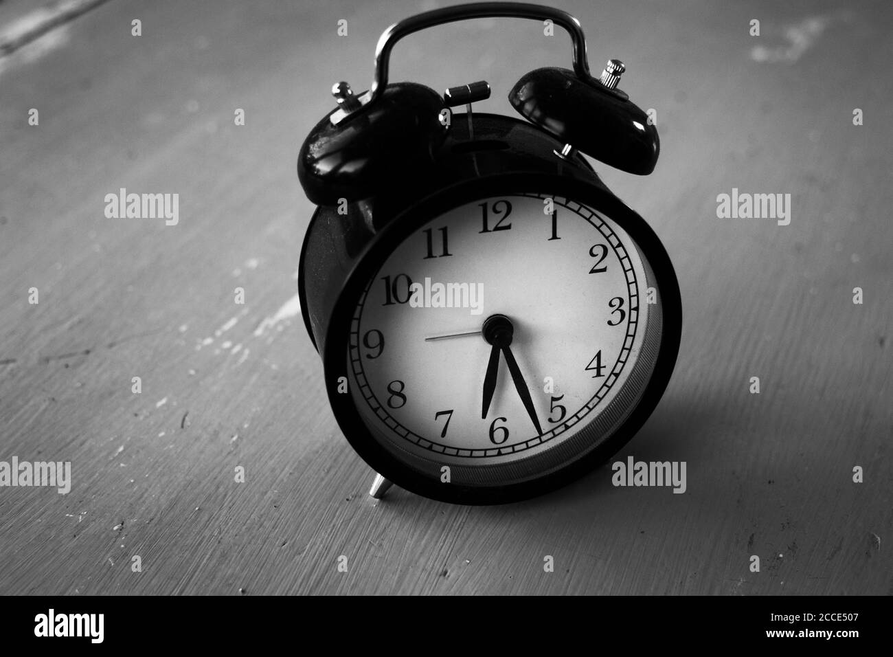 Old clock on wood table in black and white Stock Photo