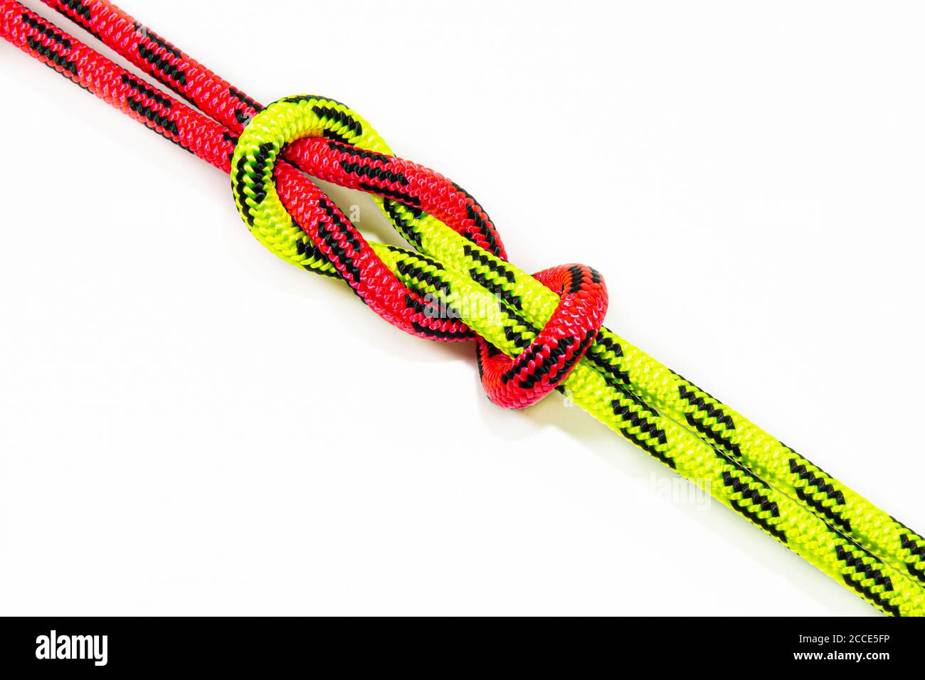 Reef, Hercules, square, double or brother hood Binding knot binding two colored red and green ropes. nautical loop used to secure rope or fishing line Stock Photo