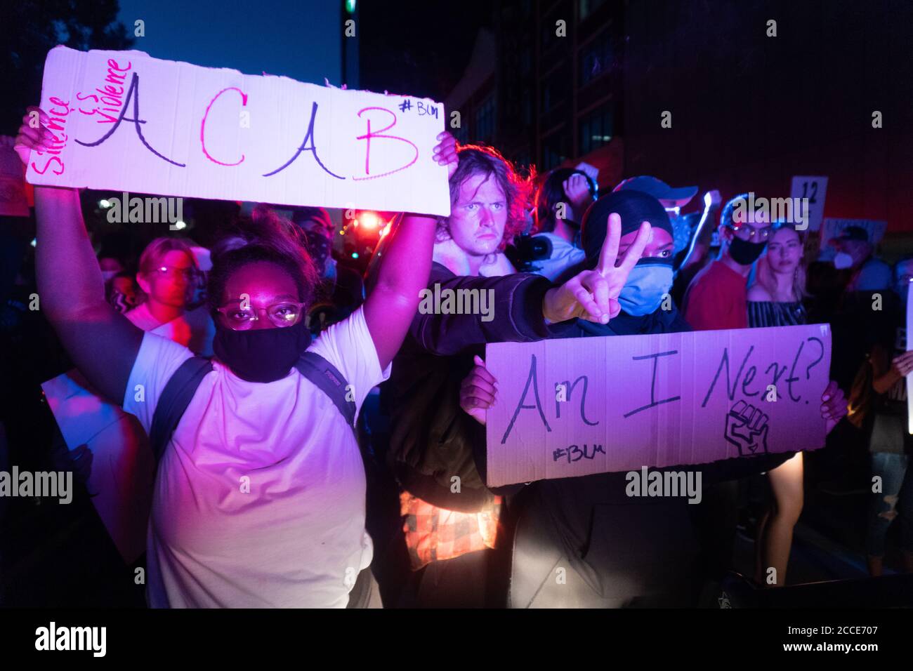Tulsa, OK, USA. 20th Jun 2020 : Black Lives Matters protesters stand in front of police officers and National Guard vehicles leaving downtown Tulsa after a Donald Trump rally. Stock Photo