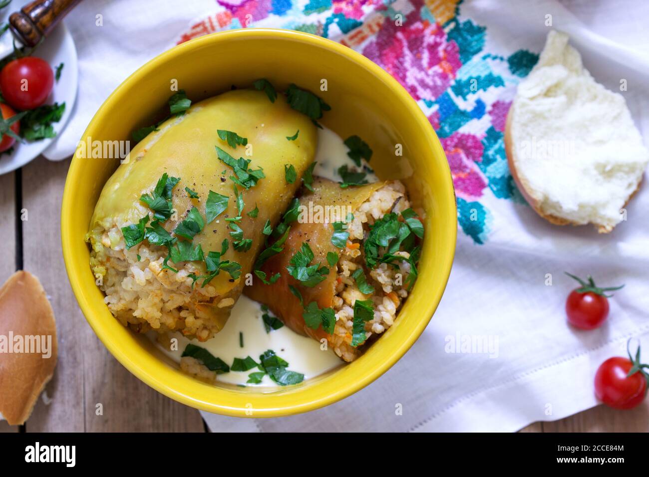 Stuffed peppers served with sour cream and bread, a traditional dish of different nations. Stock Photo
