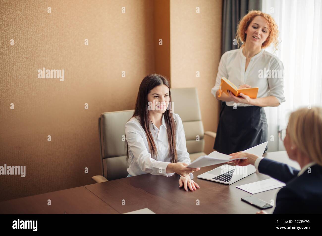 Two Young Friendly Looking Female Recruiters Listening To Brunette Candidate During Job Interview In The Office Stock Photo Alamy