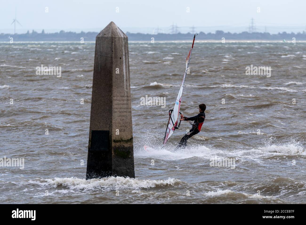 Windsurfer, windsurfing in the Thames Estuary off Southend on Sea, Essex, UK, during the high winds of Storm Ellen. Passing the CrowStone Stock Photo