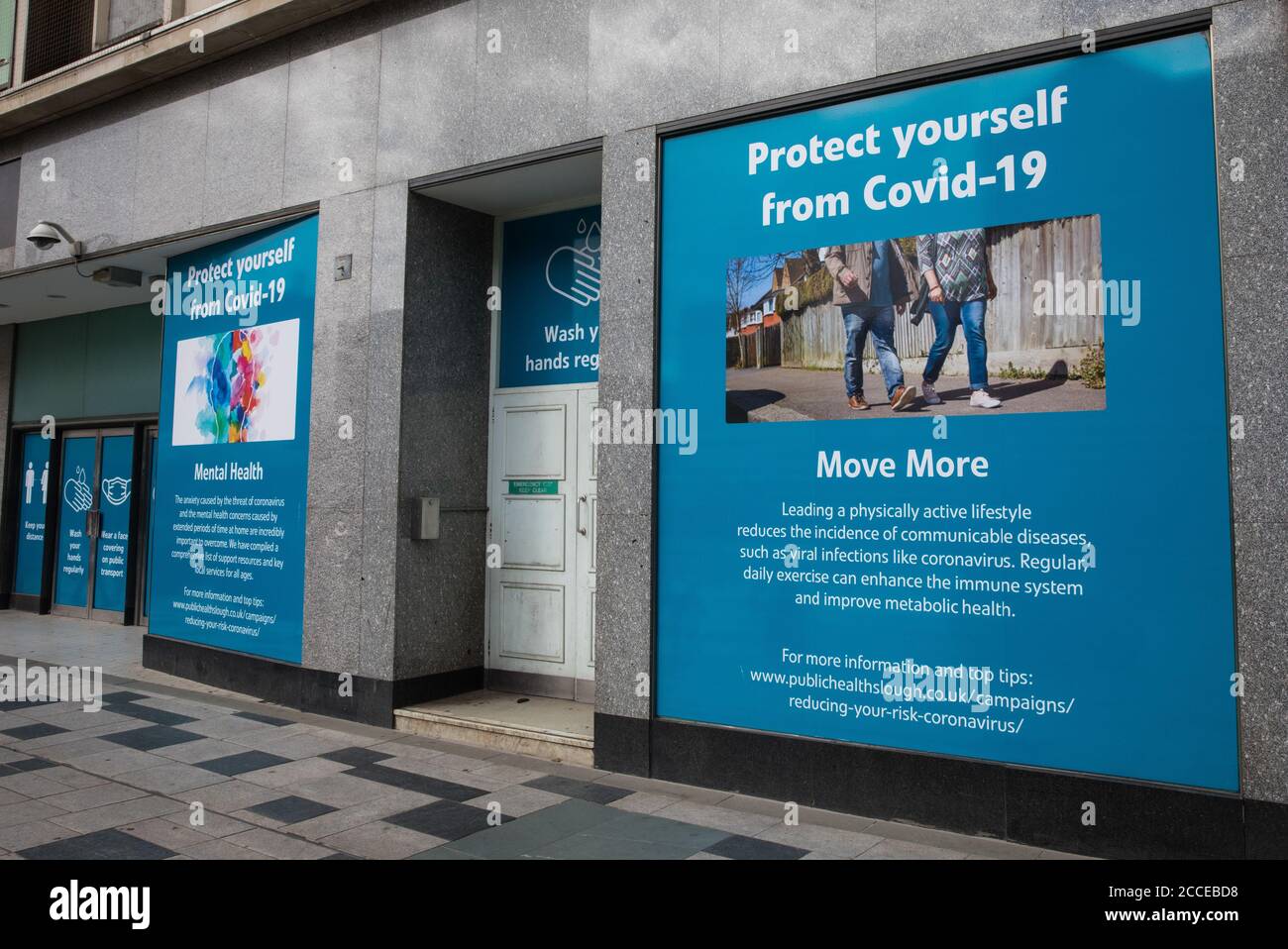 Slough, UK. 21 August, 2020. COVID-19 public information posters displayed in shop windows in the town centre. Slough has been listed by Public Health England (PHE) and the Department of Health and Social Care (DHSC) as an ‘area of concern’ for COVID-19 following a rise in positive coronavirus cases over the last two weeks. Credit: Mark Kerrison/Alamy Live News Stock Photo