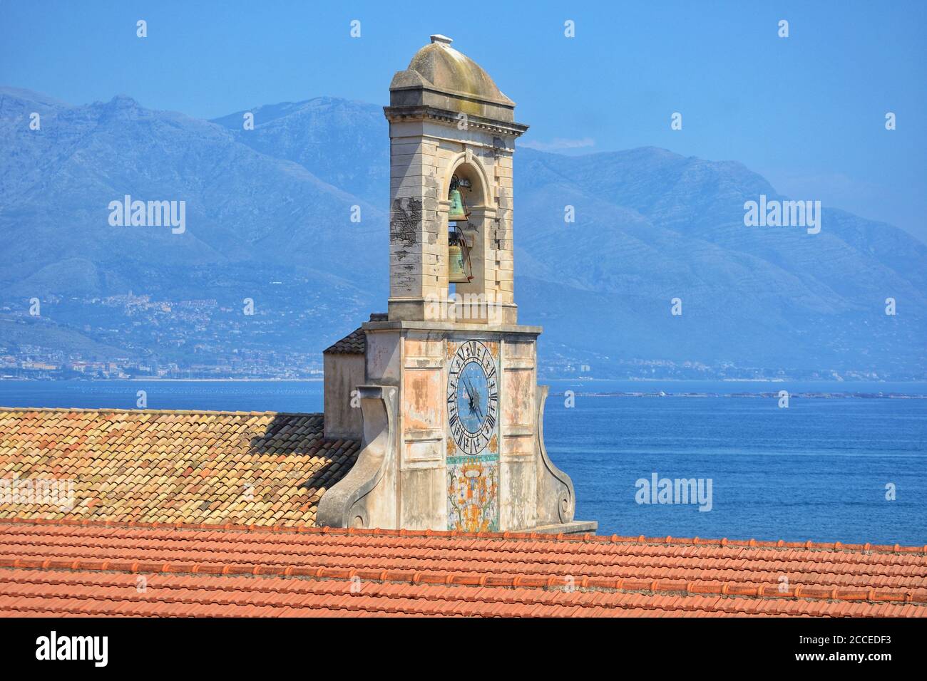 the facade of a medieval church in the historic center of gaeta and in the background the sea and the mountains of the homonymous gulf Stock Photo