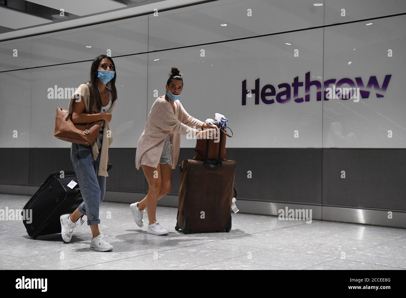 Passengers wearing face masks as they arrive at Heathrow Airport after a flight from Dubrovnik, Croatia, landed. The UK government announced that from 4am on Saturday, travellers to the UK from Croatia, Austria and Trinidad and Tobago will have to quarantine for 14 days on arrival. Stock Photo