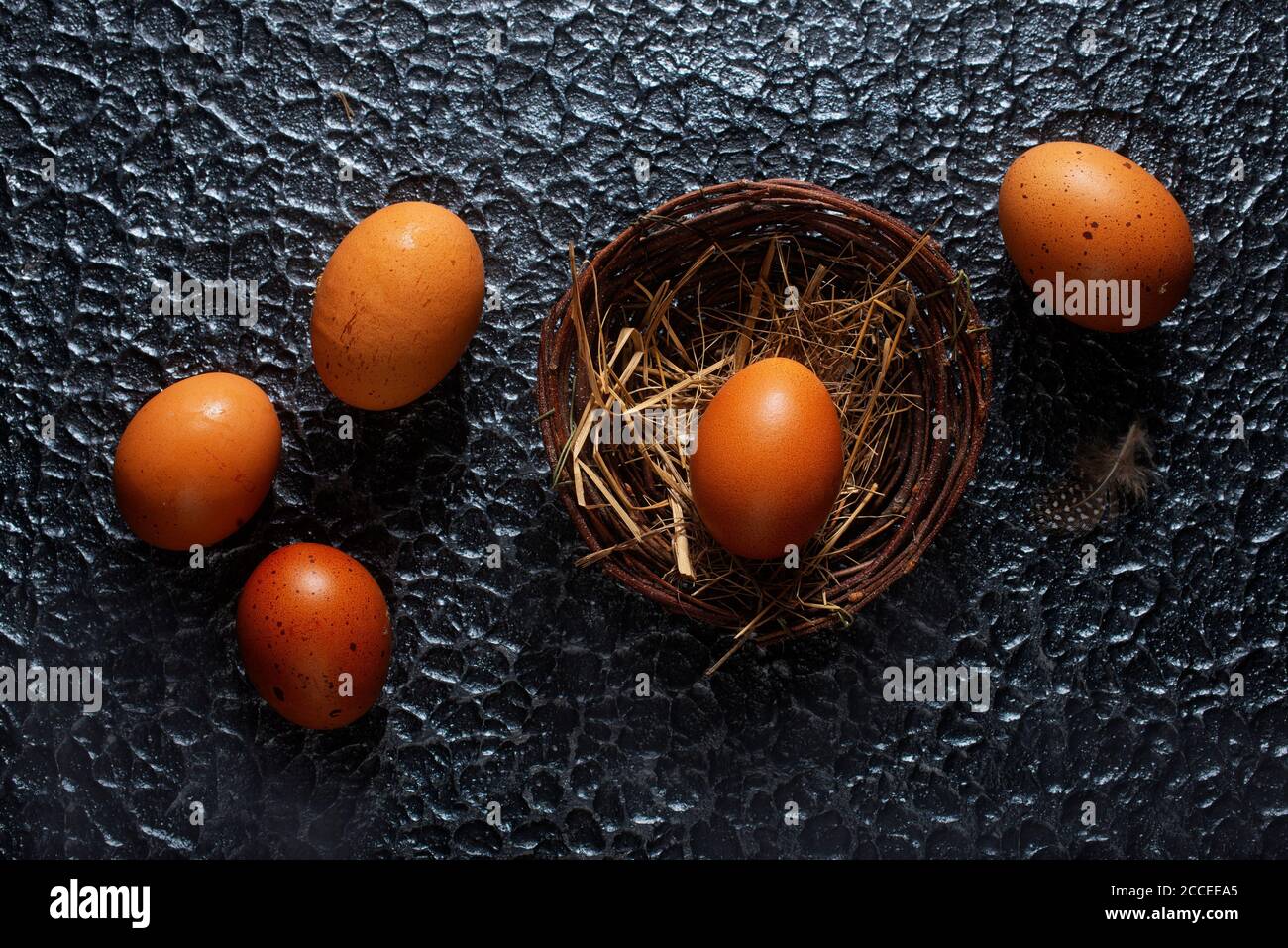 brown eggs in nest, raw chicken eggs Stock Photo