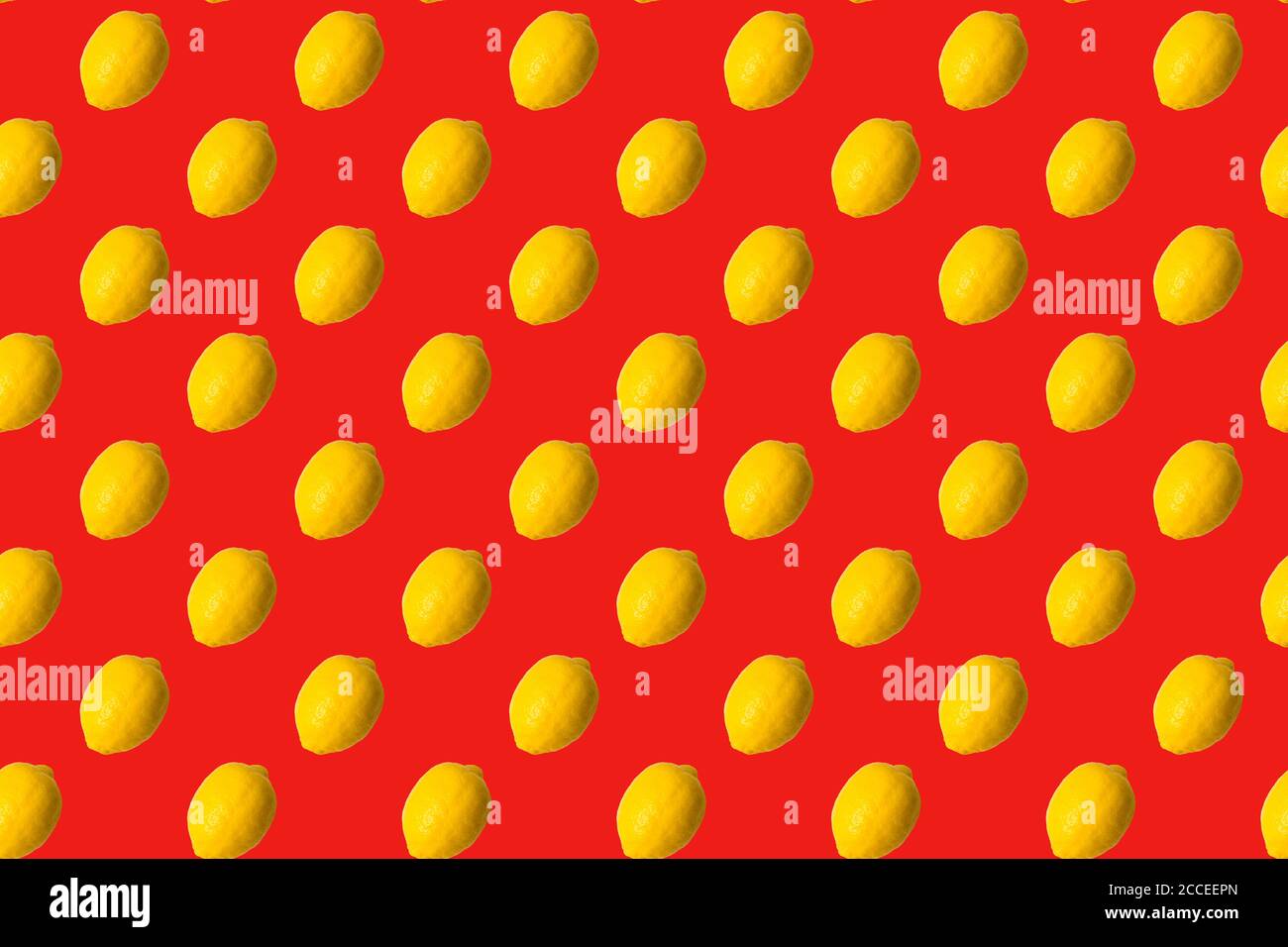 Seamless Pattern made with lemon fruit on red background. Stock Photo