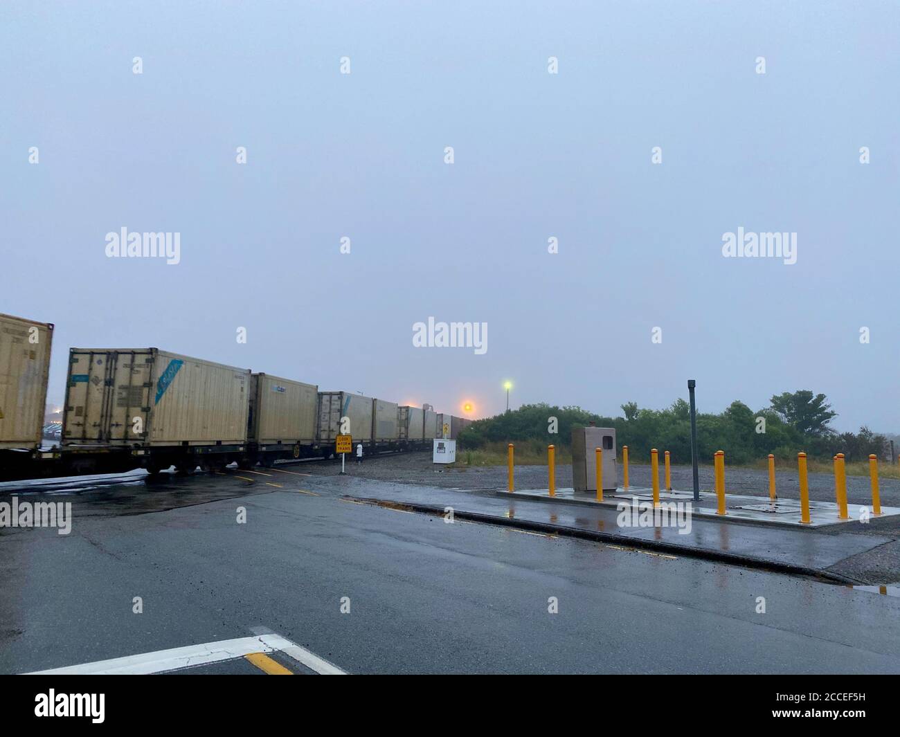 Freight train through Greymouth on a foggy evening Stock Photo