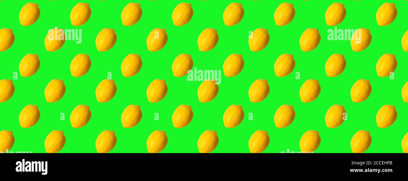 Seamless Pattern made with lemon fruit on green background. Stock Photo