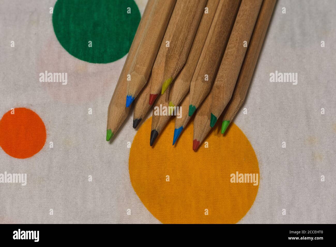 colored crayons lined up on a colored plane, horizontal image Stock Photo