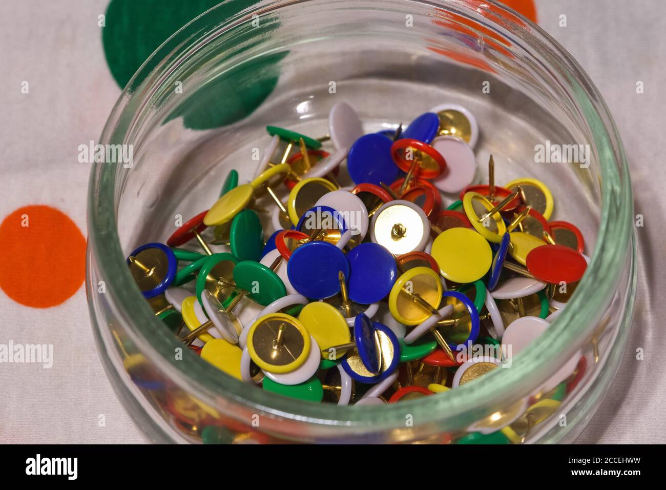 colored thumbtacks in a glass jar, horizontal image Stock Photo Alamy