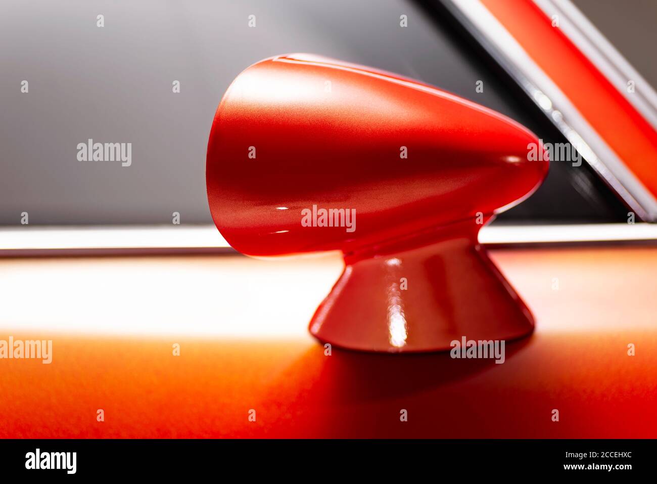 Izmir, Turkey - July 11, 2020: Close up shot of an Orange colored 1974 Pontiac Firebird’s sideview mirror. Stock Photo