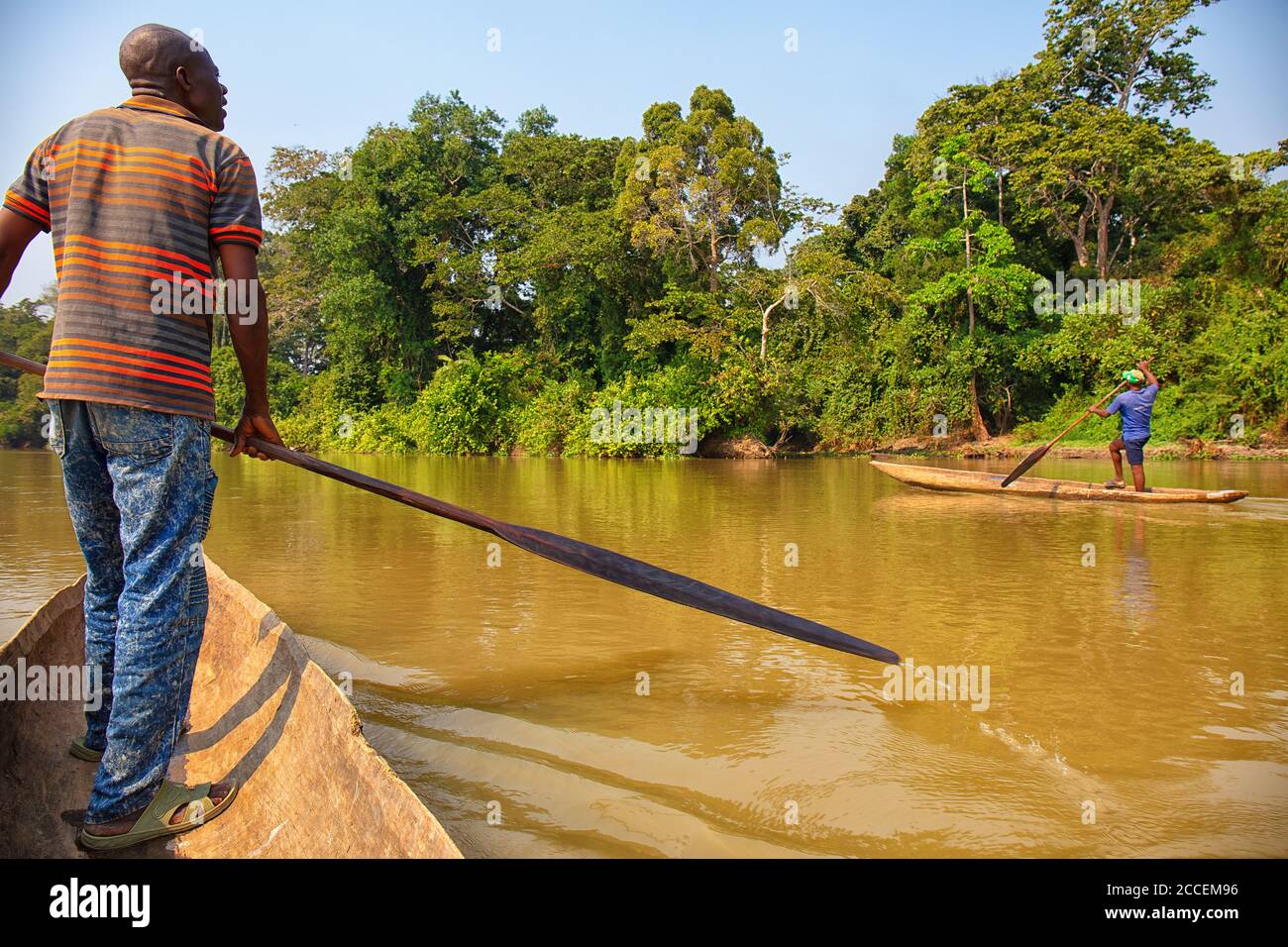 pygmy riding a boat on the Dzanga river. Dzanga Sangha National Park. Central African Republic Stock Photo