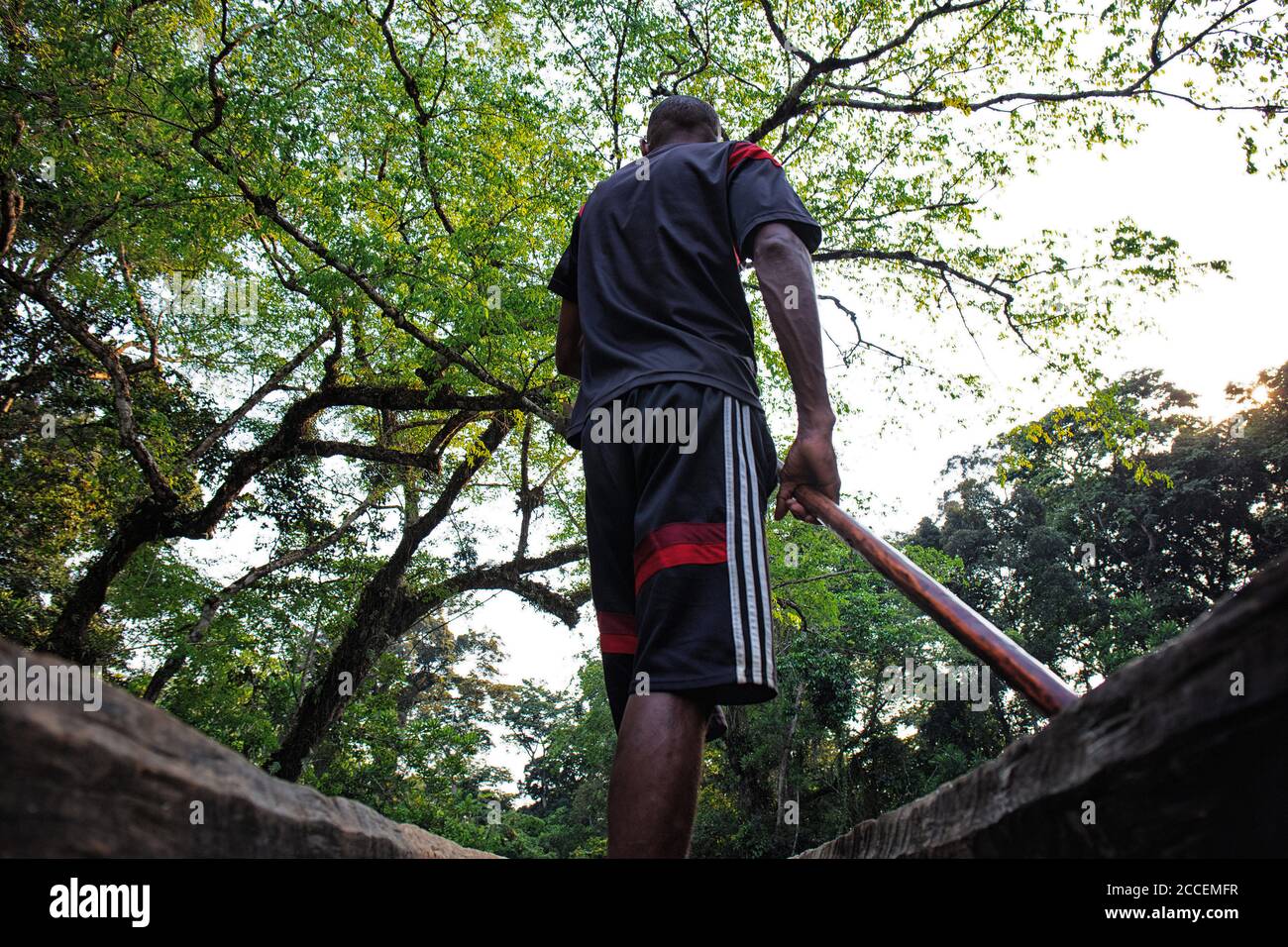 pygmy riding a boat on the Dzanga river. Dzanga Sangha National Park. Central African Republic Stock Photo