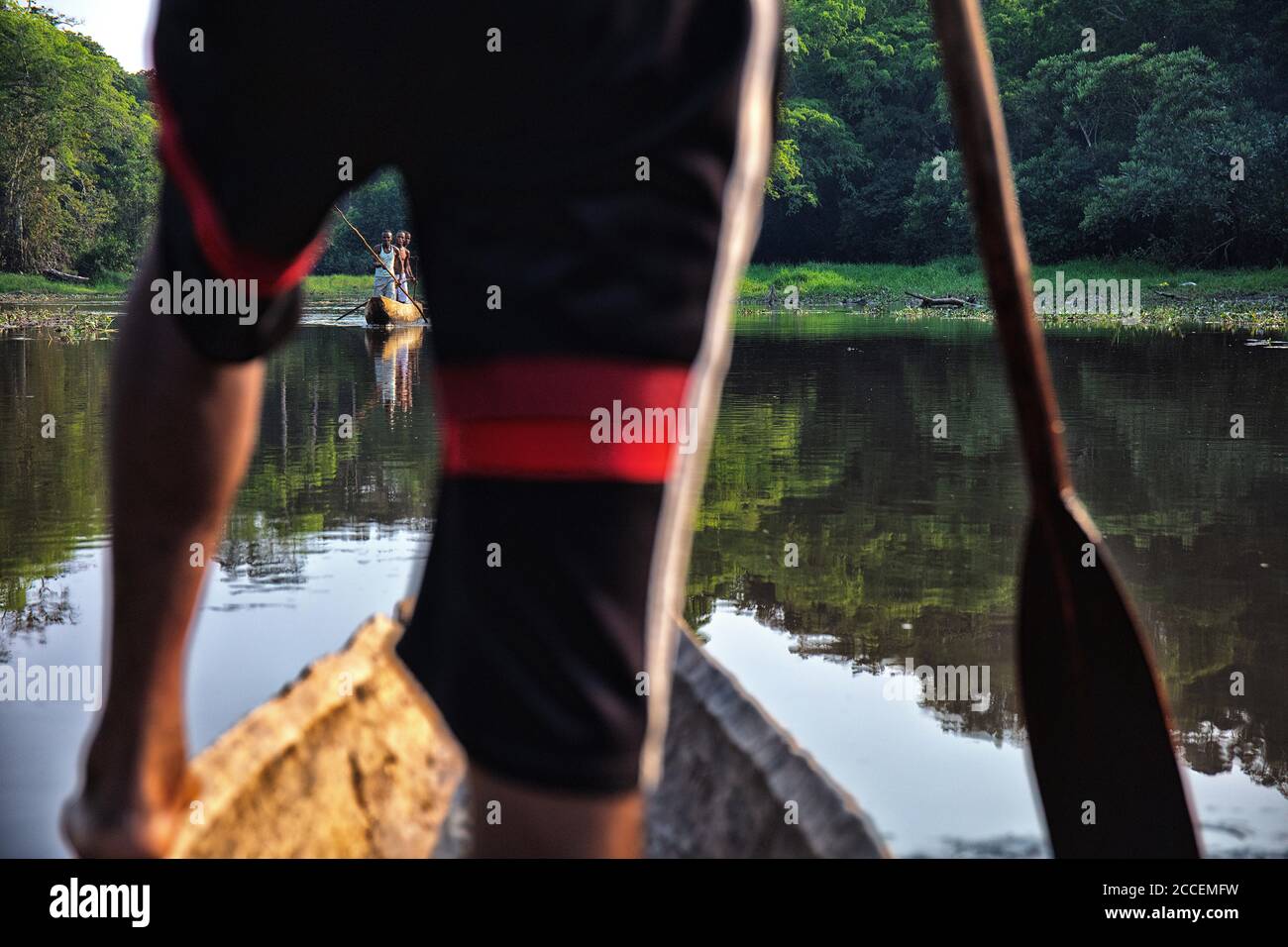 pygmy riding a boat on the Dzanga river. Dzanga Sangha National Park. Central African Republic Stock Photo