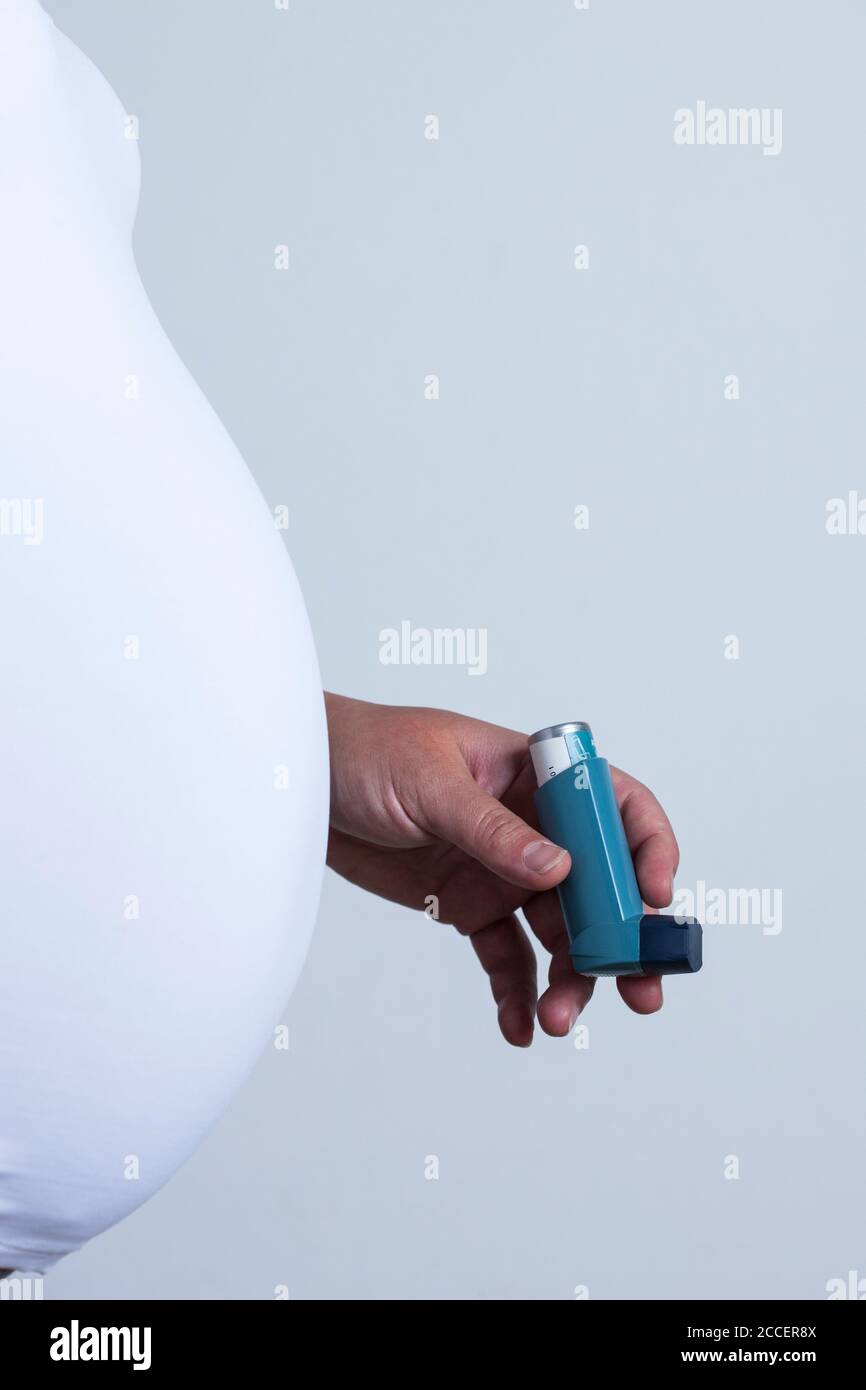 Pregnant woman holding asthma inhaler Stock Photo Alamy