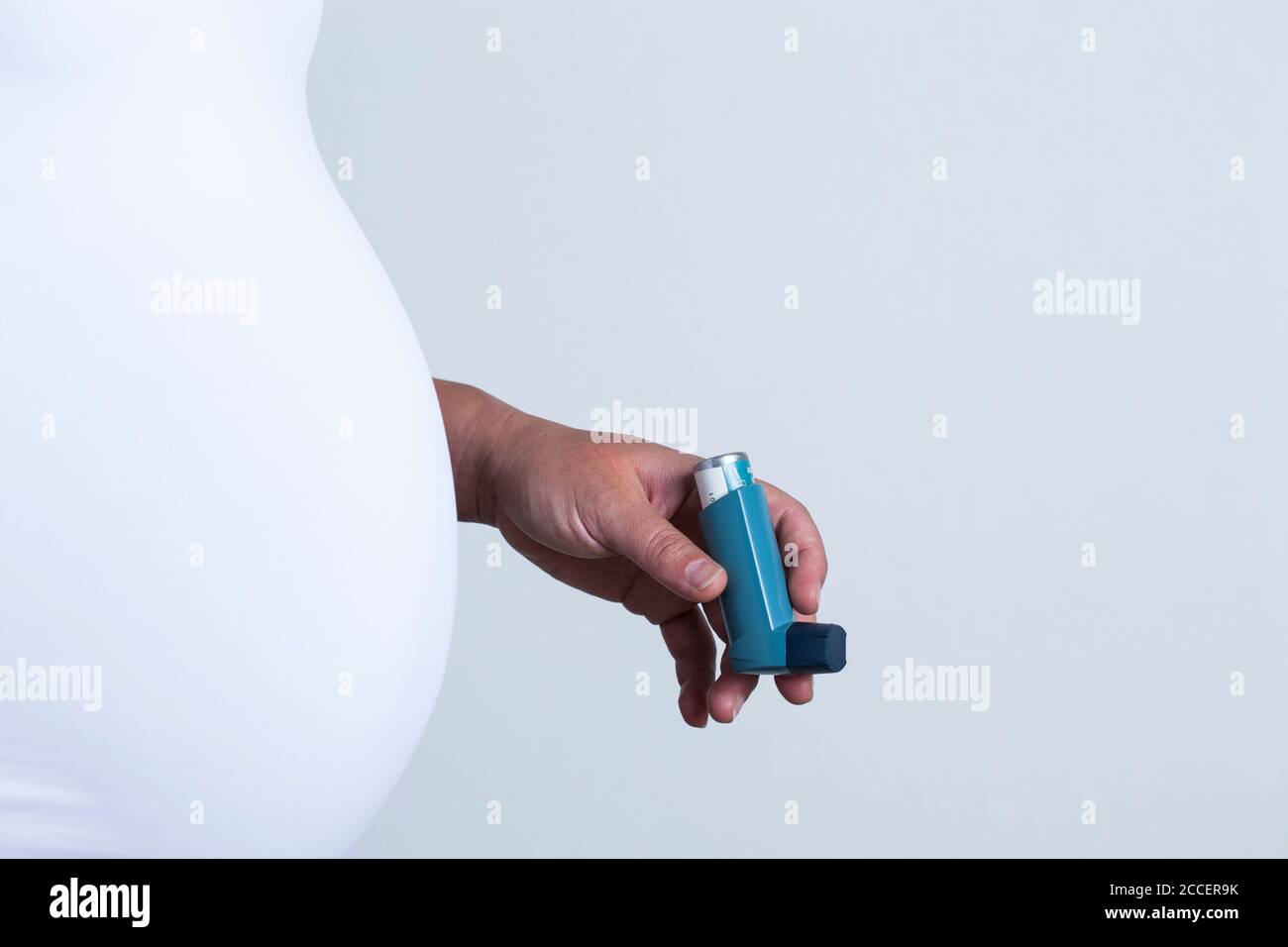 Pregnant woman holding asthma inhaler Stock Photo Alamy