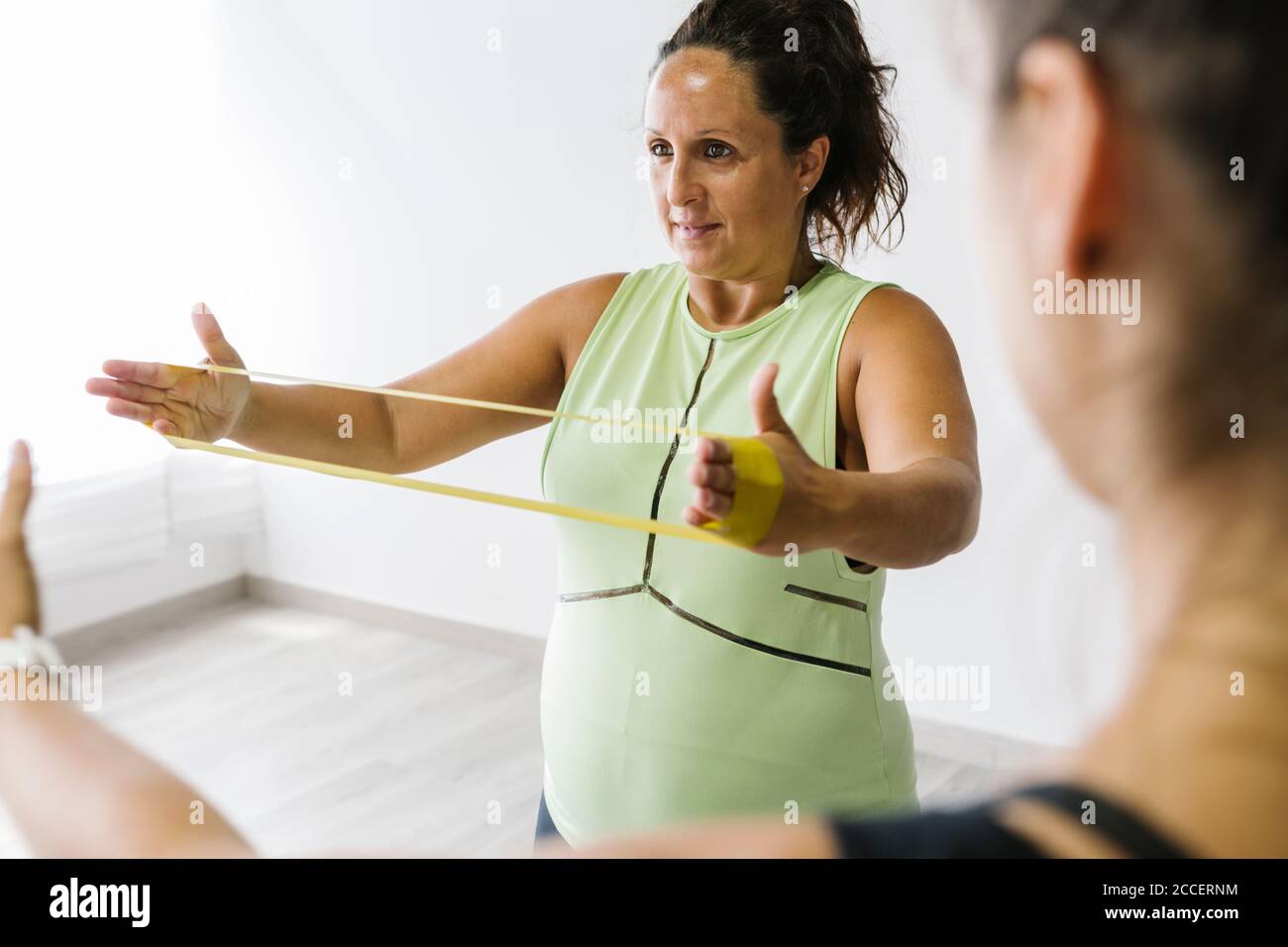 Pregnant woman exercising with rubber bands Stock Photo Alamy