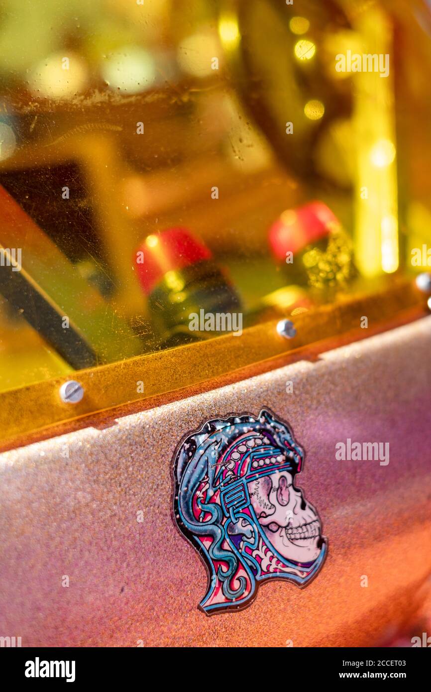 Detail of a colorful skull sticker on an old machine Stock Photo