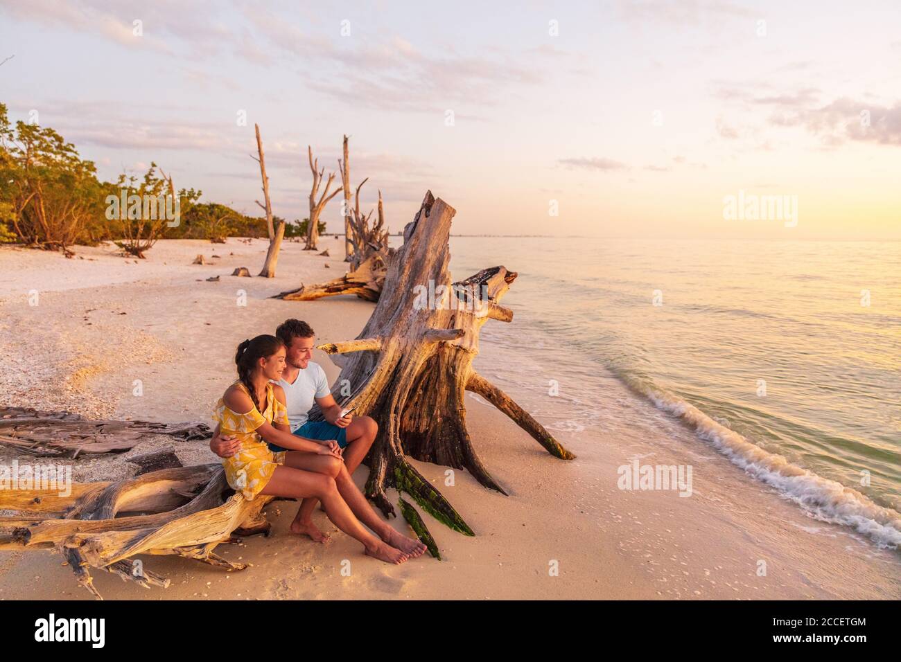 Beach Sunset Couple Relaxing On Summer Honeymoon Vacation Travel Watching Sunset At Florida Beach Gulf Of Mexico Usa Travel Man And Woman At Lover Stock Photo Alamy