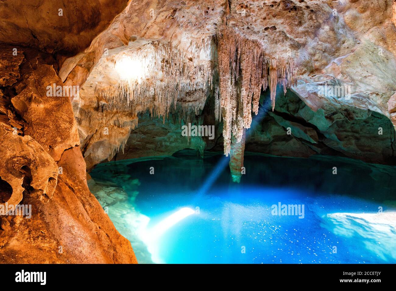 Blue Cenote with sunlight from the top,Yucatan,Mexico Stock Photo