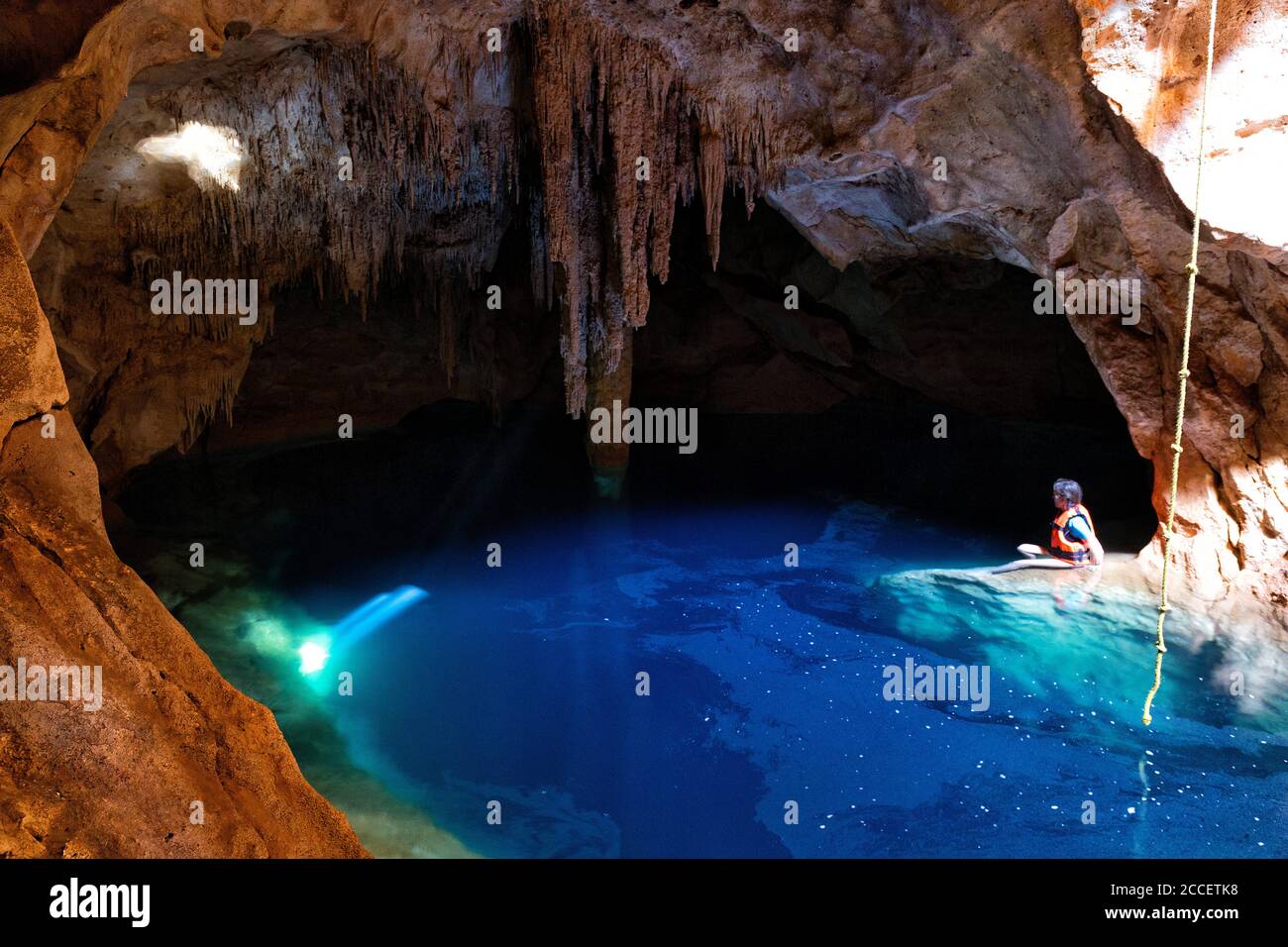 Blue Cenote with sunlight from the top,Yucatan,Mexico Stock Photo