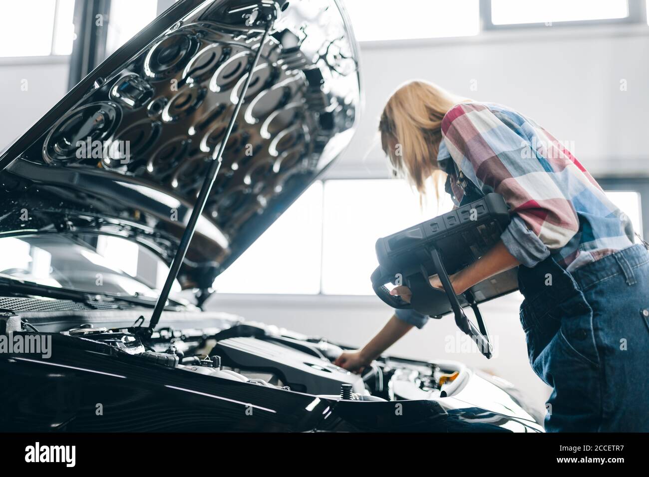 side view close up photo. girl trying to find out the mechanical