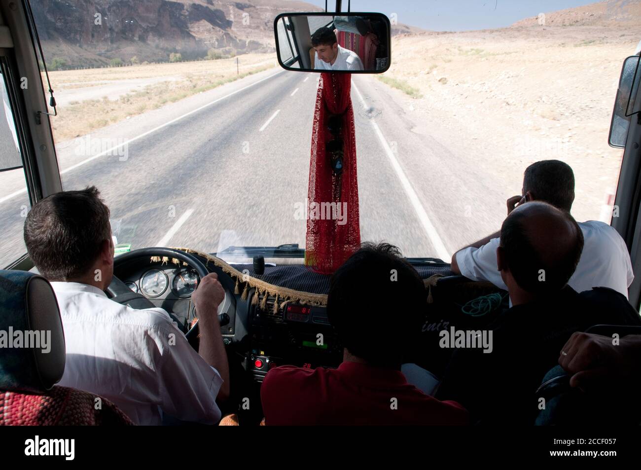 A driver and passengers at the front of an intercity bus on a rural highway near the city of Van, in the eastern Anatolia region, southeastern Turkey. Stock Photo