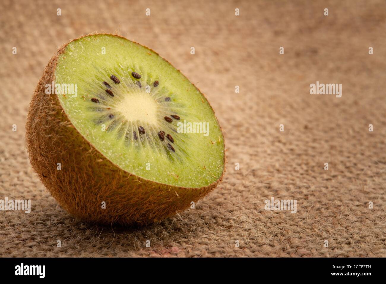 Half Kiwi Fruits On Sackcloth Stock Photo