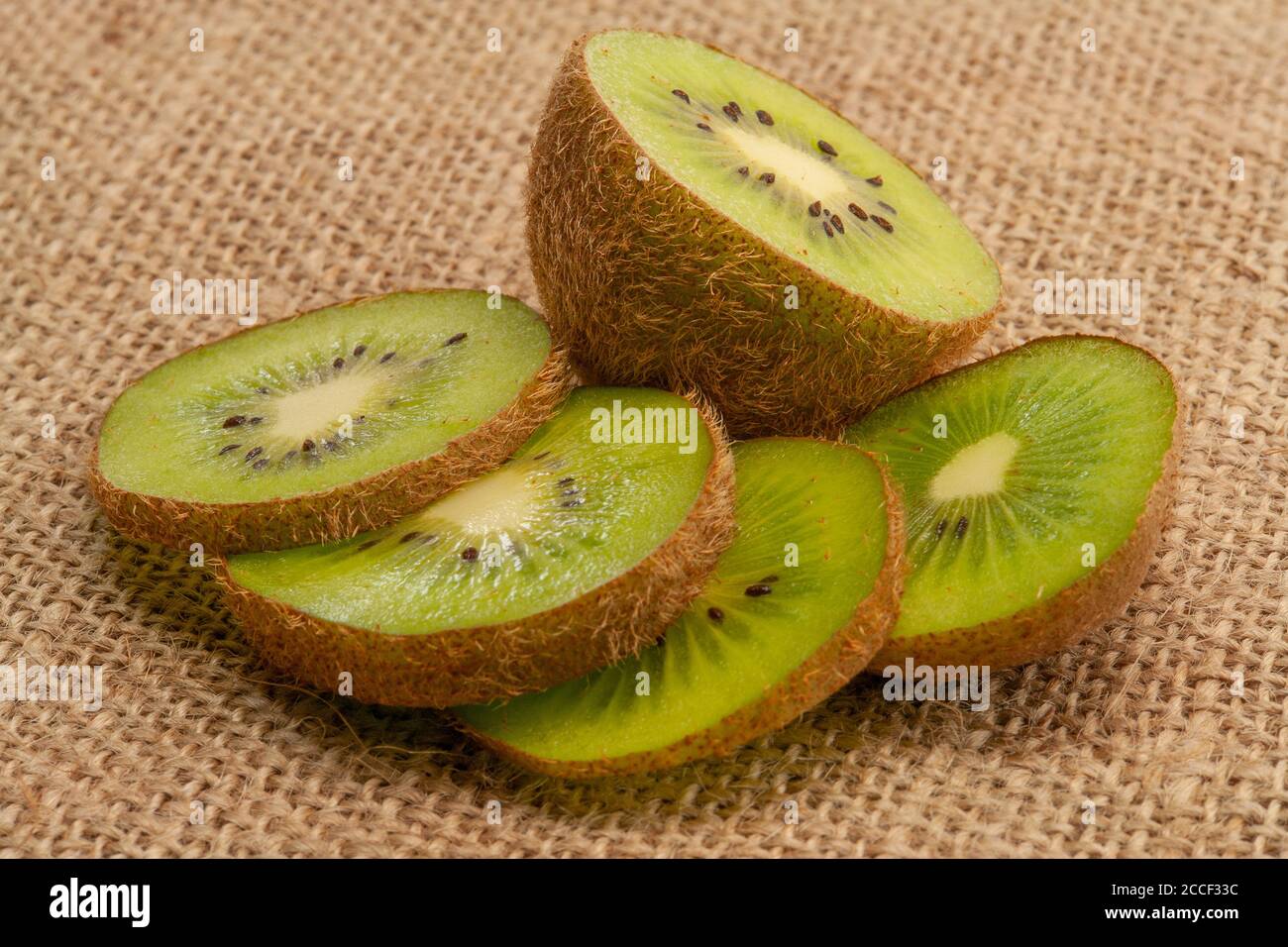 Sliced Kiwi Fruits On Sackcloth Stock Photo