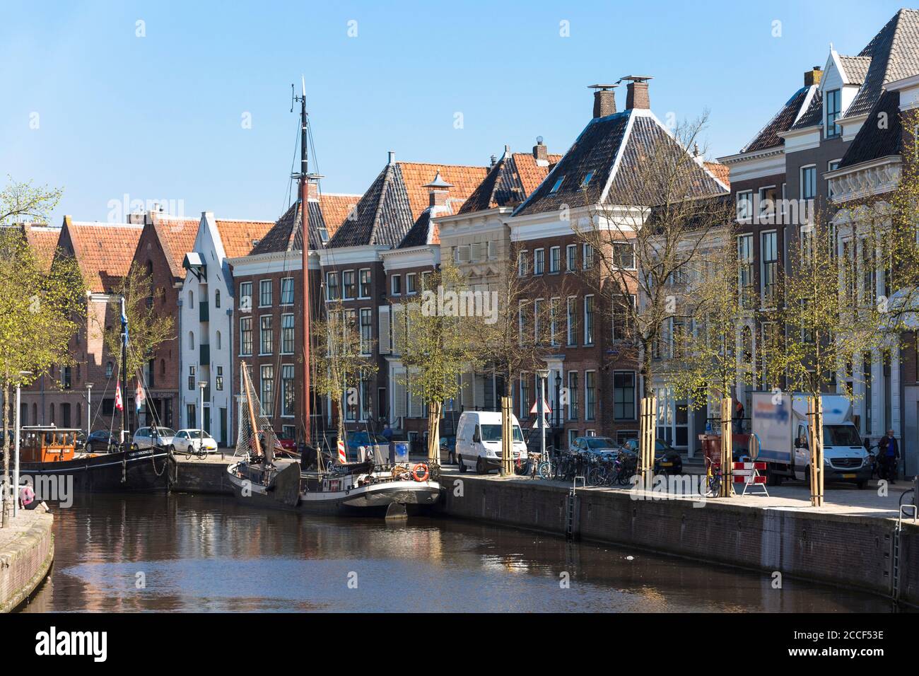 View of the canals with the old traditional sailing ships and the historic houses in the city center of Groningen, Netherlands Stock Photo