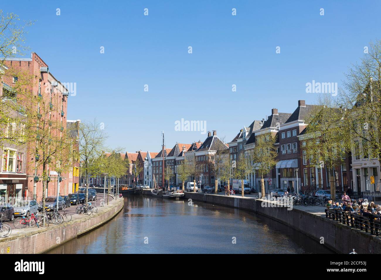 View of the canals with the old traditional sailing ships and the historic houses in the city center of Groningen, Netherlands Stock Photo