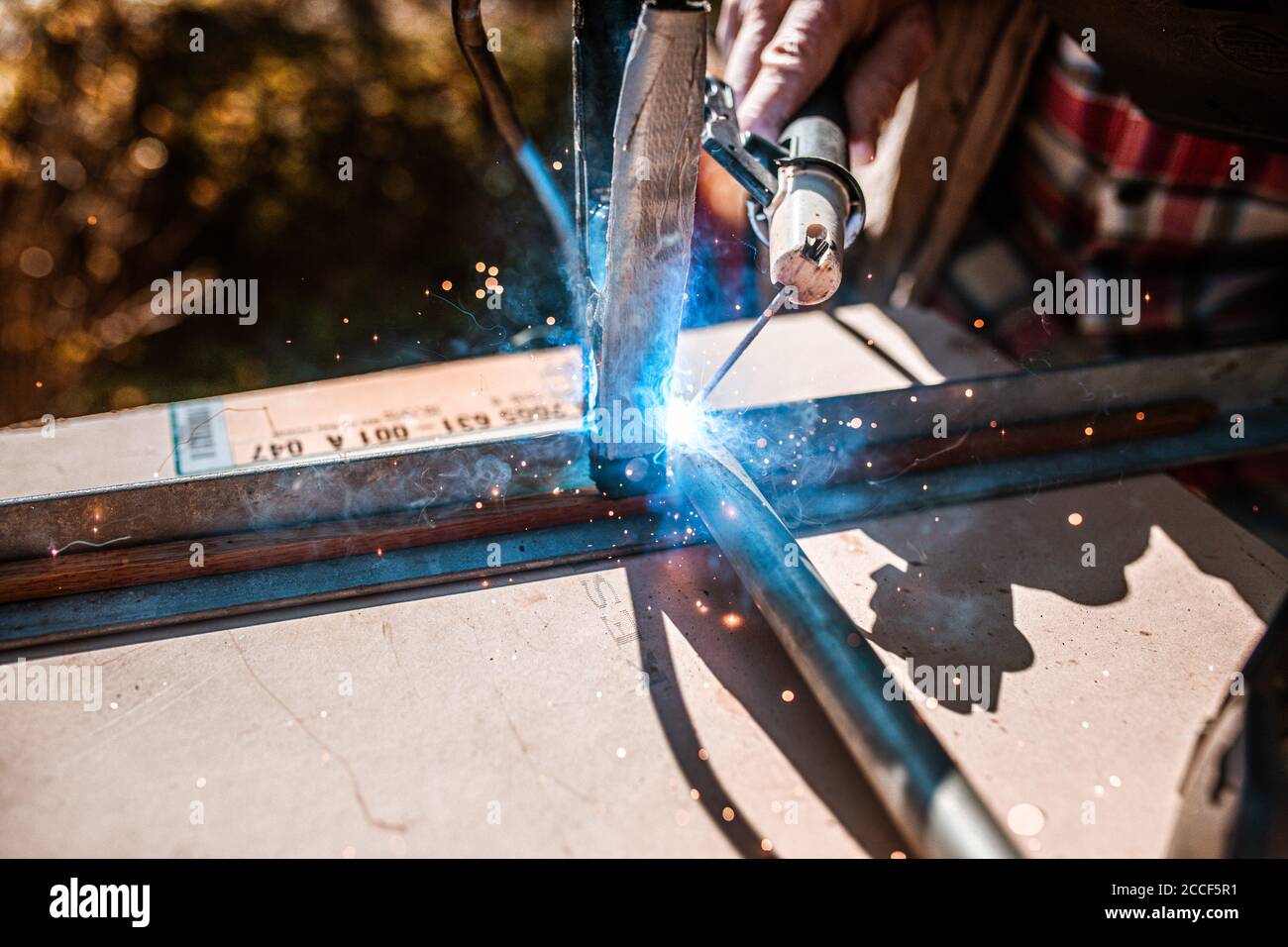 Arc welding on a workpiece with flying sparks, hobby craftsmen Stock Photo