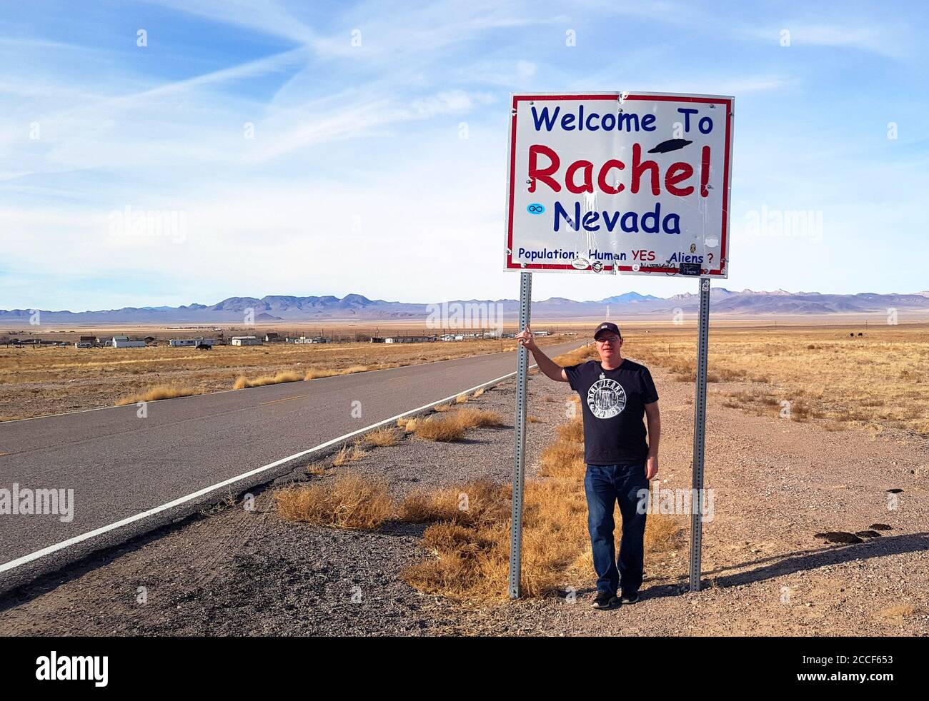 A tourist stands in front of the famous Rachel Nevada sign, Rachel Nevada USA Stock Photo