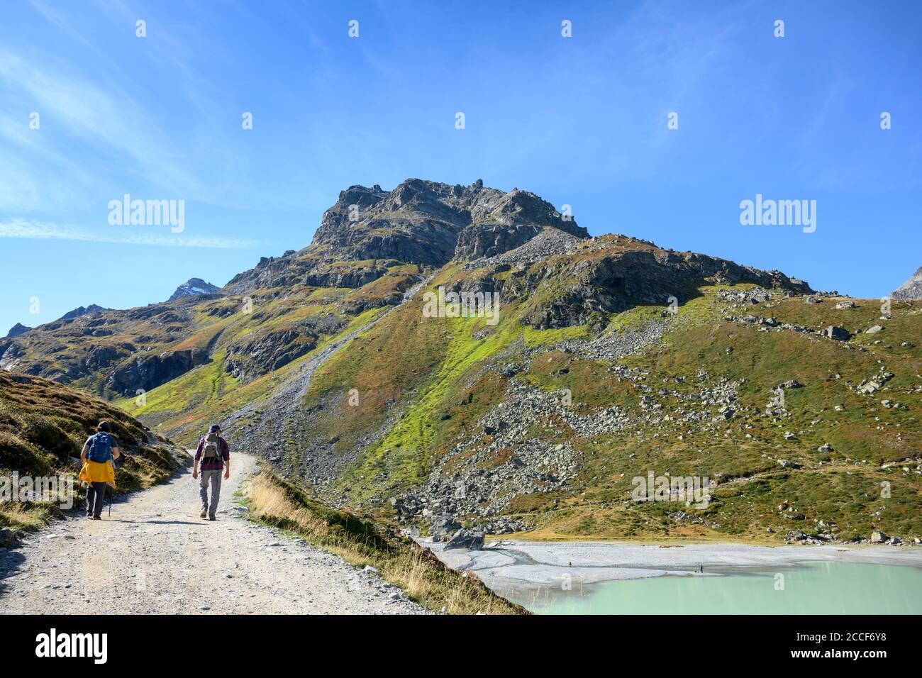 Austria, Montafon, hikers at Lake Silvretta, in the background the Kleine Schattenspitze, 2703 m above sea level Stock Photo